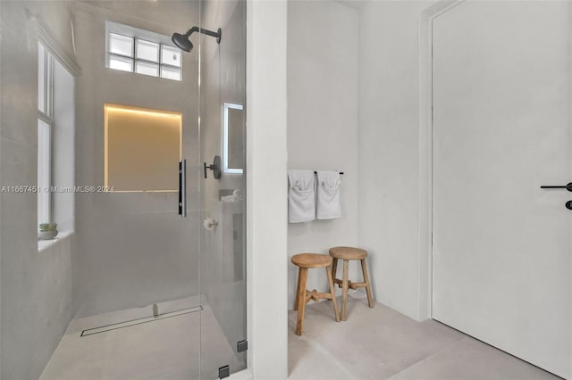 bathroom with a shower with shower door