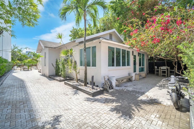 rear view of property featuring a patio