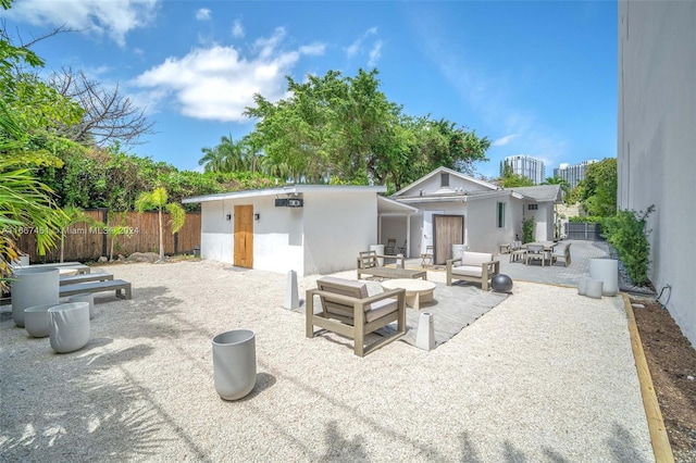 rear view of property with an outdoor hangout area and a patio area