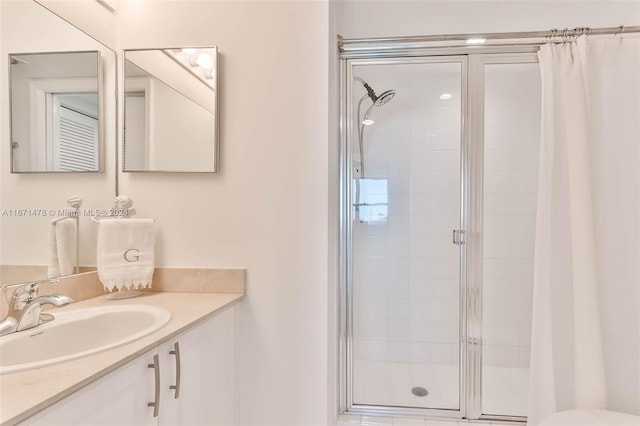 bathroom with vanity and a shower with door