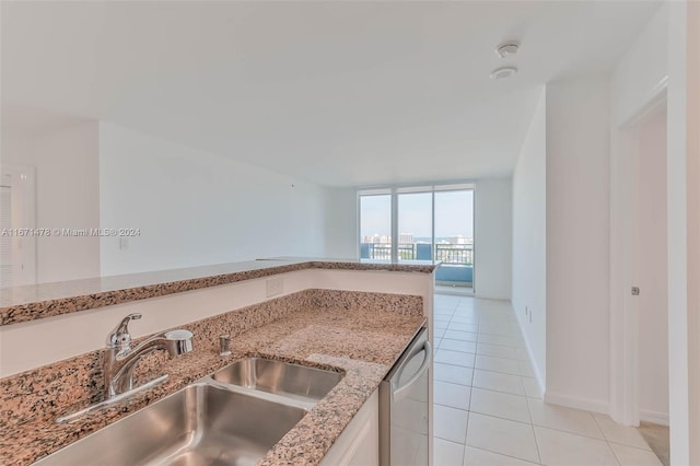 kitchen featuring sink, light tile patterned floors, and stainless steel dishwasher