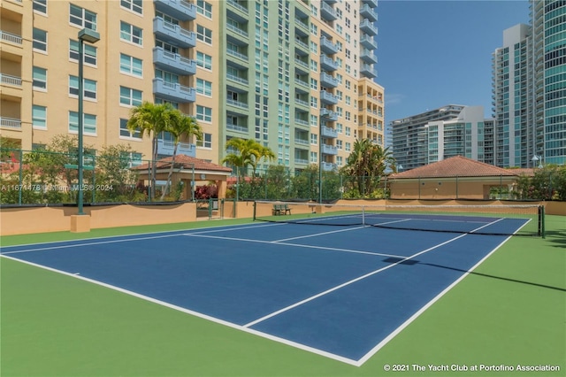 view of tennis court with basketball hoop