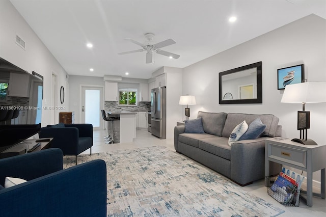 tiled living room with ceiling fan