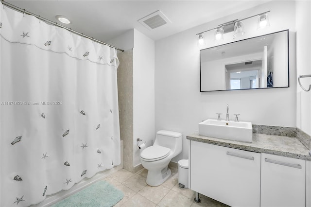 full bathroom featuring vanity, shower / bath combo with shower curtain, toilet, and tile patterned floors