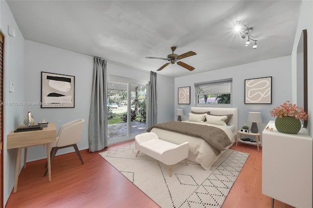 bedroom with ceiling fan, wood-type flooring, and access to outside