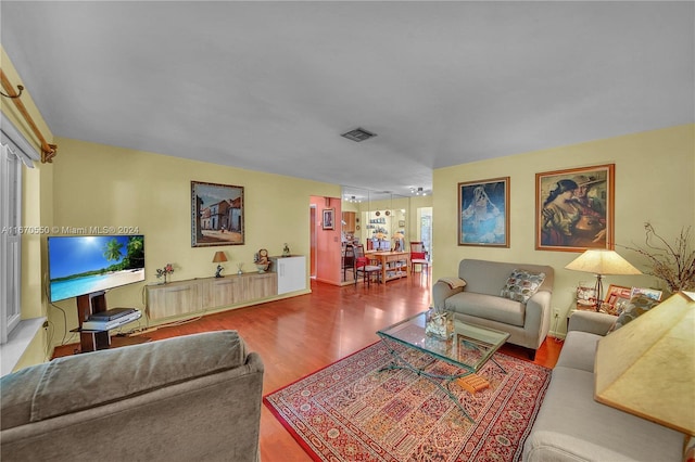 living room with a wealth of natural light and hardwood / wood-style flooring