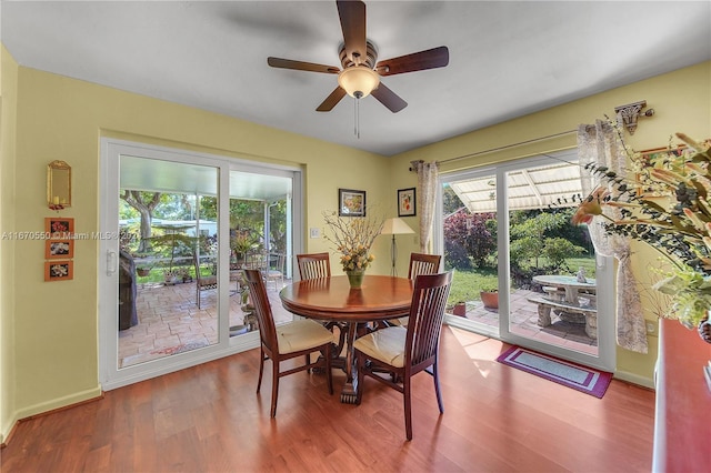 dining space with hardwood / wood-style flooring and ceiling fan