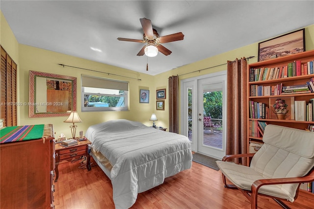 bedroom featuring access to exterior, light hardwood / wood-style flooring, and ceiling fan