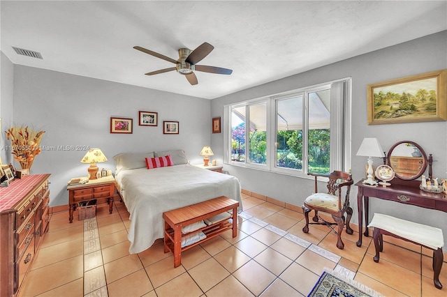 tiled bedroom featuring ceiling fan