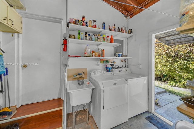 laundry area with cabinets and washing machine and clothes dryer