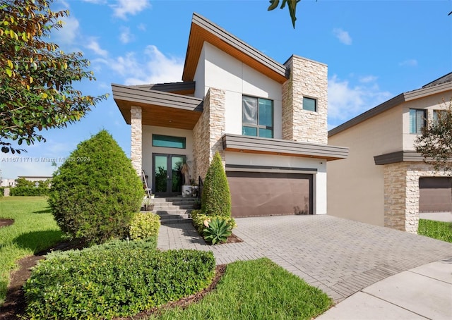 contemporary house featuring french doors and a garage