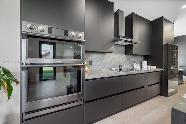 kitchen with black appliances, decorative backsplash, and wall chimney range hood