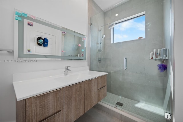 bathroom featuring vanity and an enclosed shower