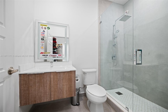 bathroom with vanity, an enclosed shower, and toilet