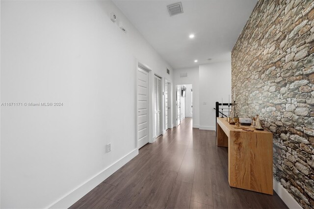 hallway featuring dark hardwood / wood-style flooring