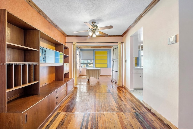 4701 Mainland Dr, Tamarac, FL 33319 - hall featuring ornamental molding, light wood-type flooring, a textured ceiling, and baseboards