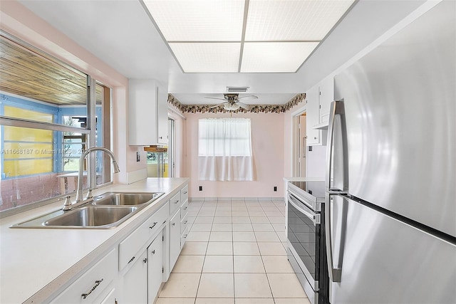 4701 Mainland Dr, Tamarac, FL 33319 - kitchen with stainless steel appliances, a sink, light countertops, a ceiling fan, and white cabinetry
