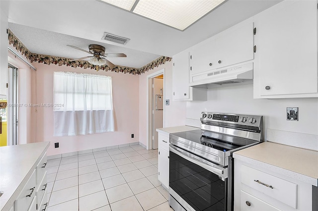 4701 Mainland Dr, Tamarac, FL 33319 - kitchen with electric range, under cabinet range hood, a ceiling fan, light countertops, and white cabinetry