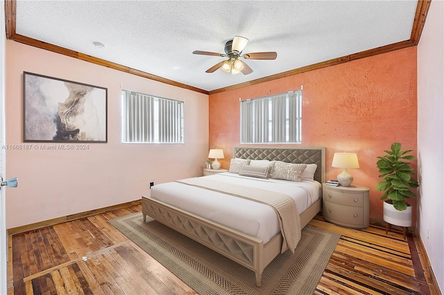 bedroom with wood-type flooring, a textured ceiling, crown molding, and ceiling fan