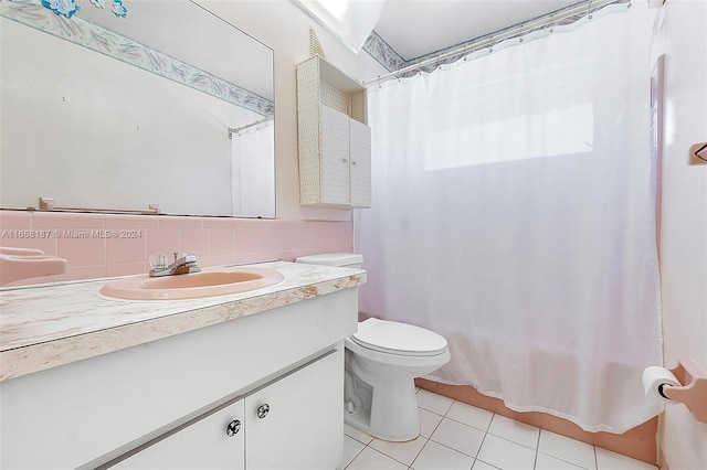 bathroom with decorative backsplash, tile patterned floors, vanity, and toilet