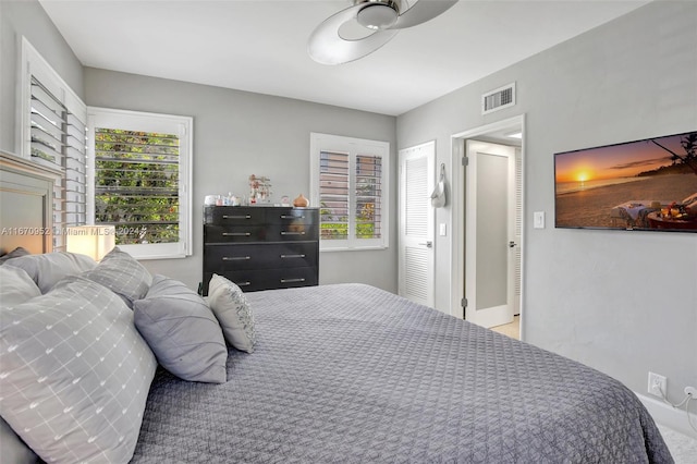 bedroom featuring multiple windows and ceiling fan