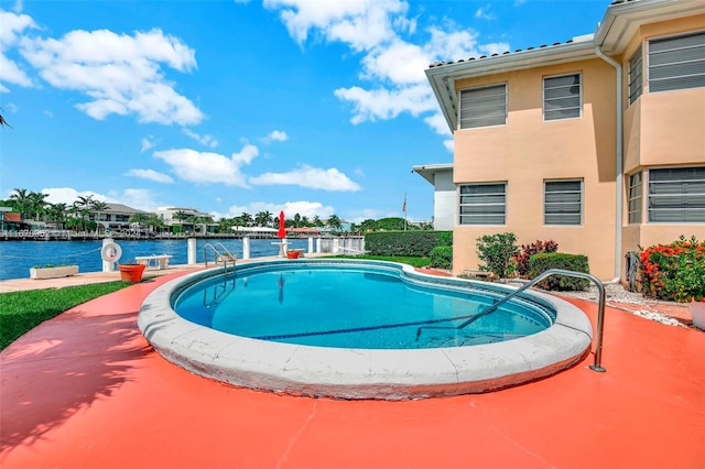 view of swimming pool with a water view