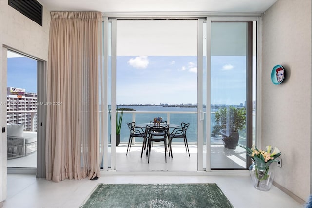 interior space featuring a water view and concrete flooring