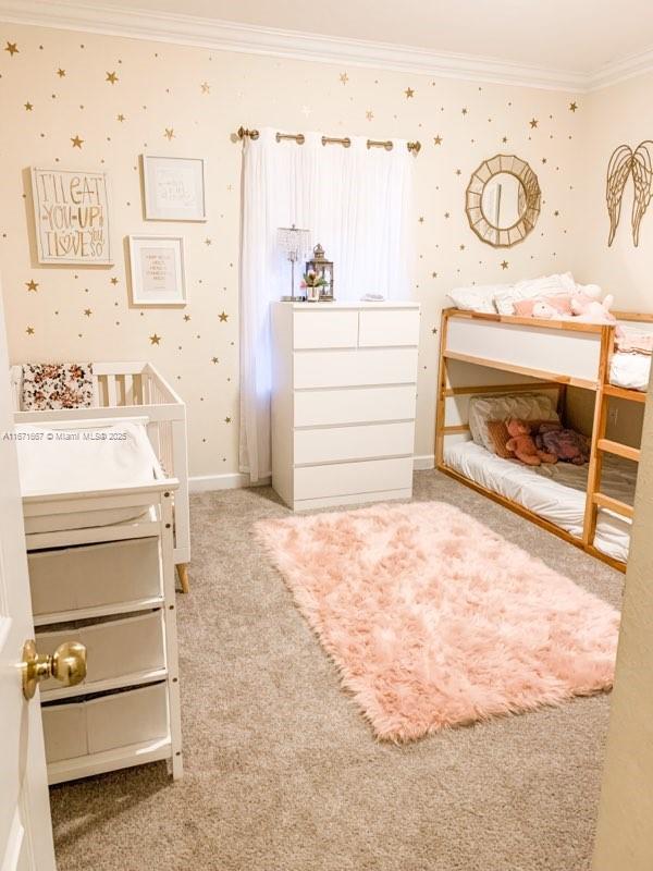 carpeted bedroom featuring crown molding