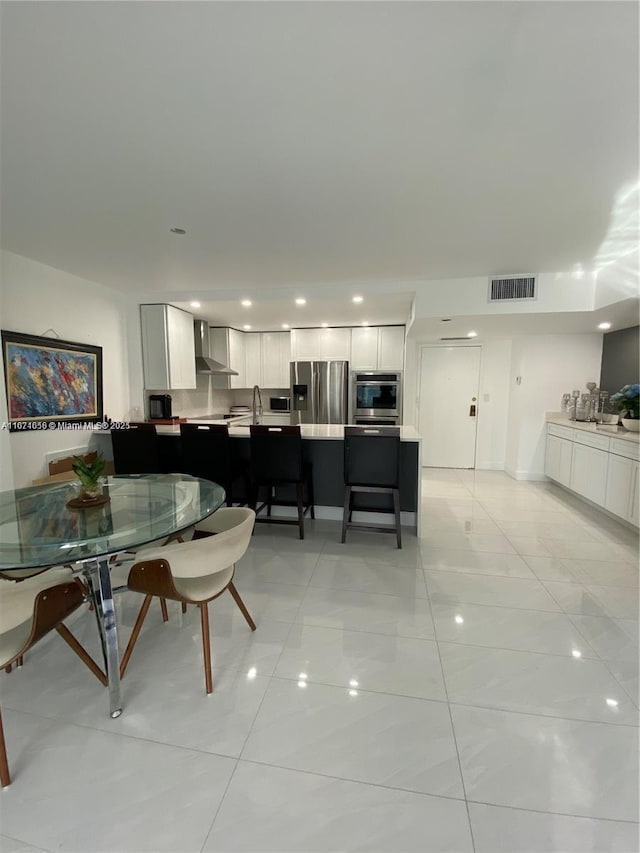 dining area with light tile patterned flooring, recessed lighting, and visible vents