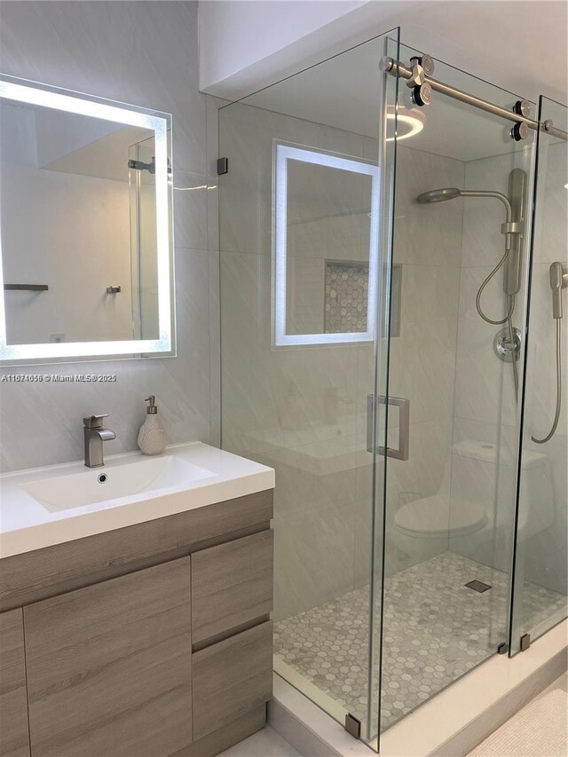 bathroom featuring an enclosed shower and vanity