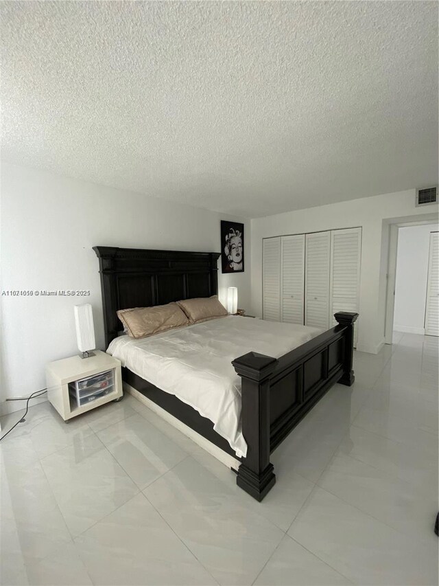 bedroom featuring a textured ceiling