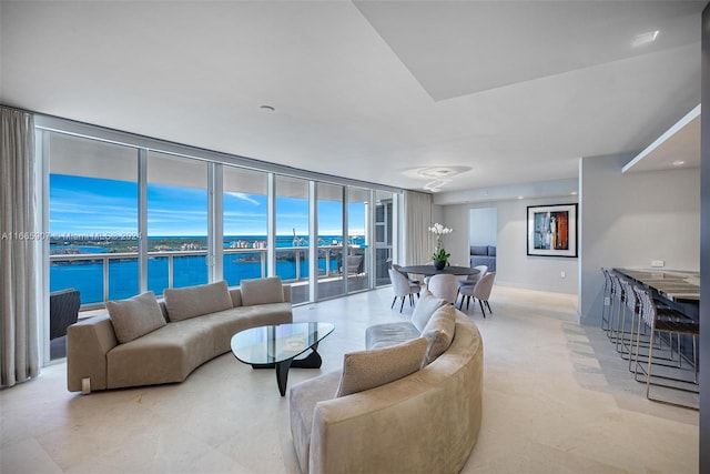 living room with floor to ceiling windows and a water view