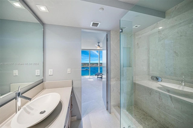 bathroom featuring a water view, vanity, and tiled shower