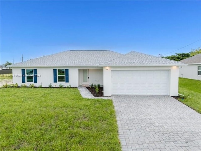 ranch-style home with a garage and a front lawn