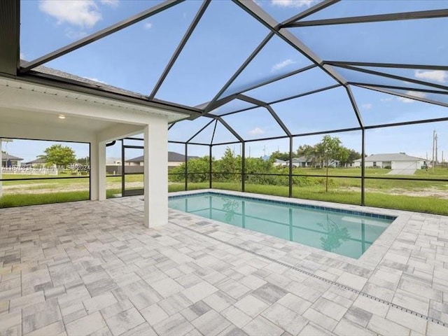 view of swimming pool with a lanai, a patio, and a yard