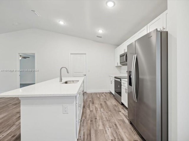 kitchen with appliances with stainless steel finishes, white cabinetry, sink, and an island with sink