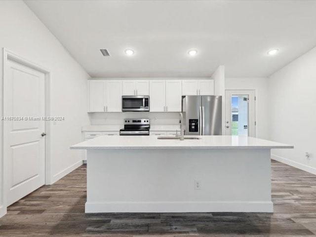 kitchen featuring white cabinetry, an island with sink, dark hardwood / wood-style flooring, stainless steel appliances, and sink