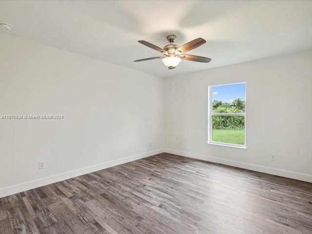 spare room featuring wood-type flooring and ceiling fan