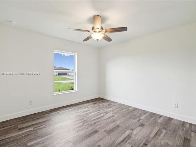 empty room with wood-type flooring and ceiling fan