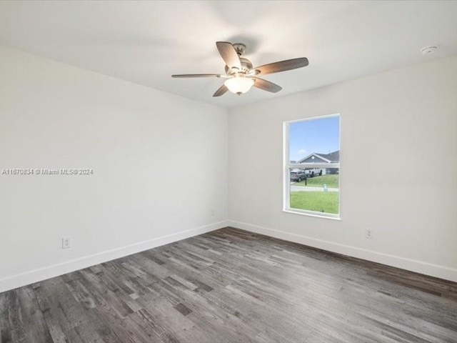 empty room with ceiling fan and dark hardwood / wood-style floors