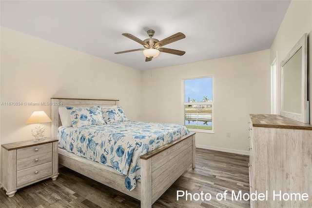 bedroom with dark hardwood / wood-style floors and ceiling fan