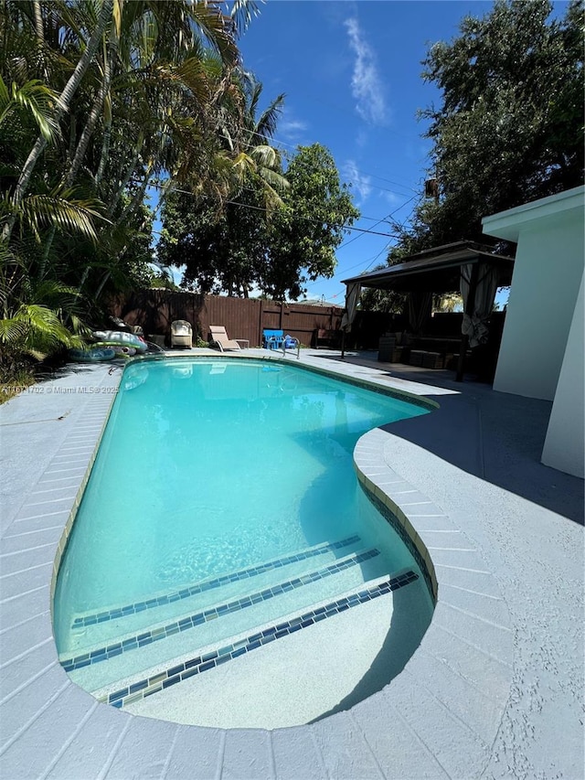 view of pool featuring a fenced in pool, outdoor lounge area, a patio, a gazebo, and a fenced backyard