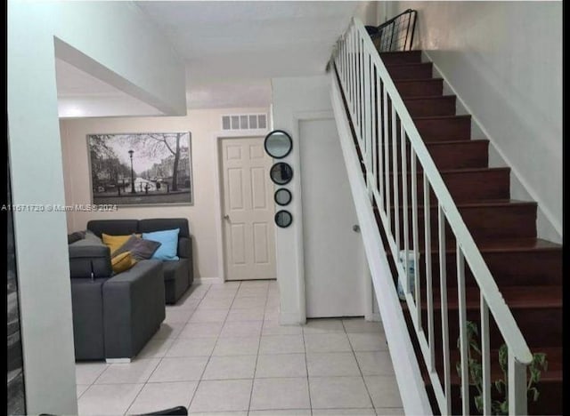 stairway with tile patterned floors