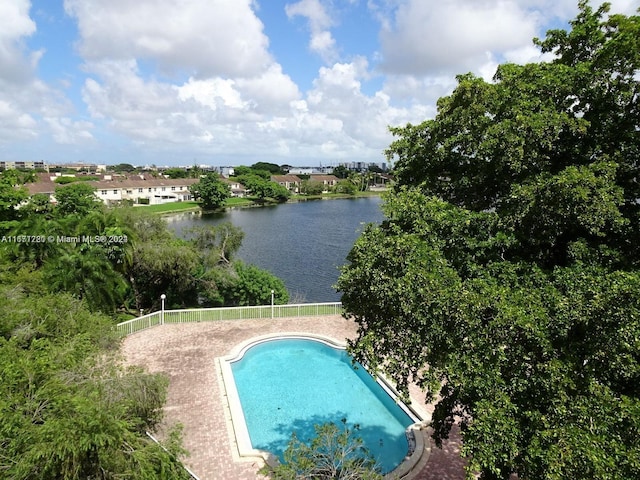 view of swimming pool with a water view