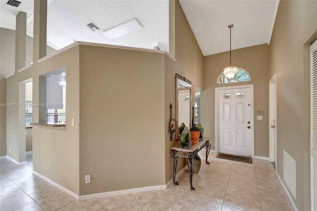 entrance foyer featuring plenty of natural light, light tile patterned floors, and high vaulted ceiling