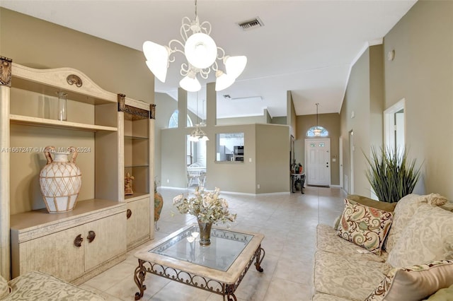 tiled living room with an inviting chandelier and high vaulted ceiling