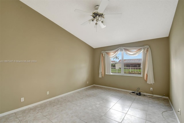 unfurnished room with ceiling fan and vaulted ceiling