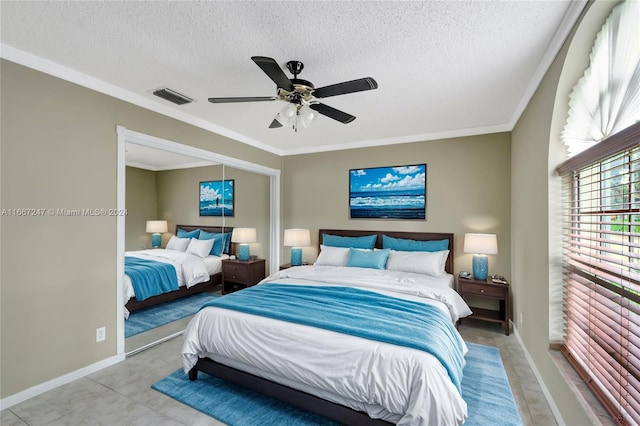 bedroom with ceiling fan, a textured ceiling, and crown molding