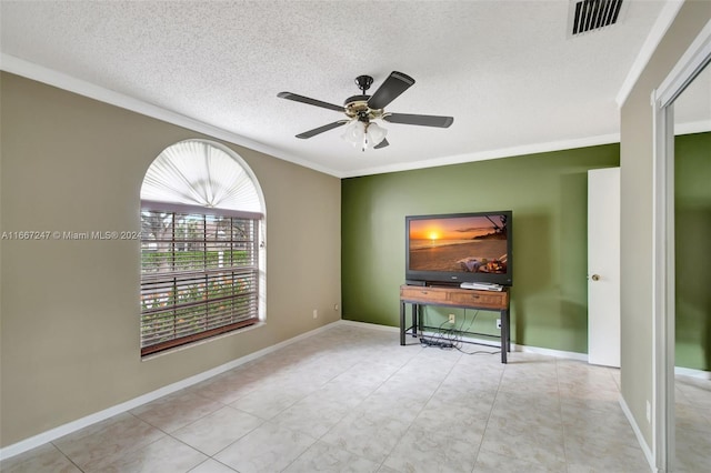 empty room with a textured ceiling, crown molding, and ceiling fan