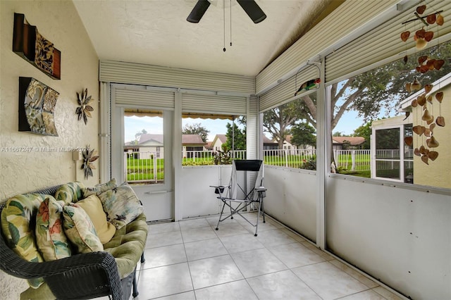 sunroom / solarium featuring ceiling fan